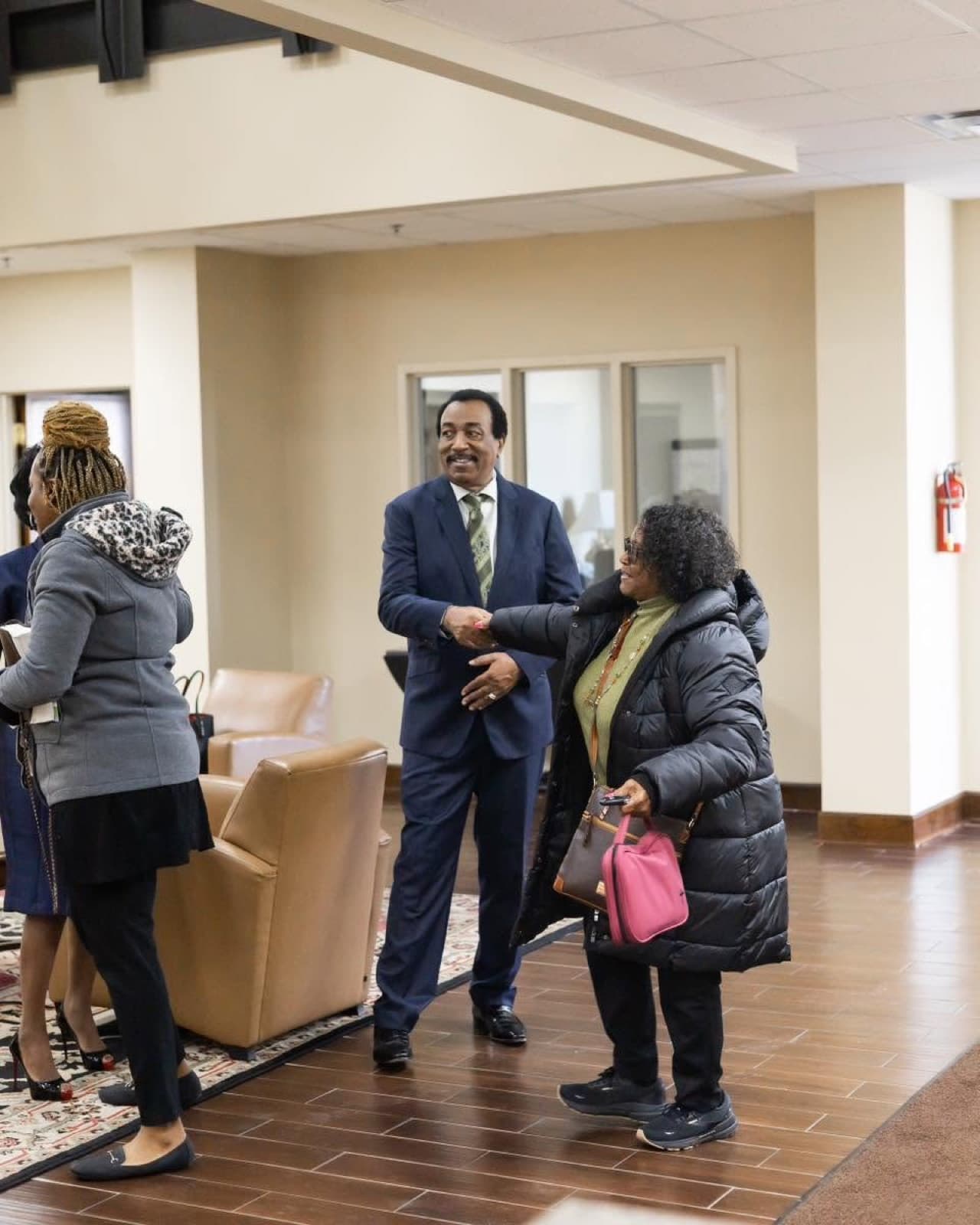 Pastor Emmanuel Simmons welcoming a guest at All Nations Church of God